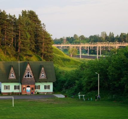 a green house with a soccer goal in front of it
