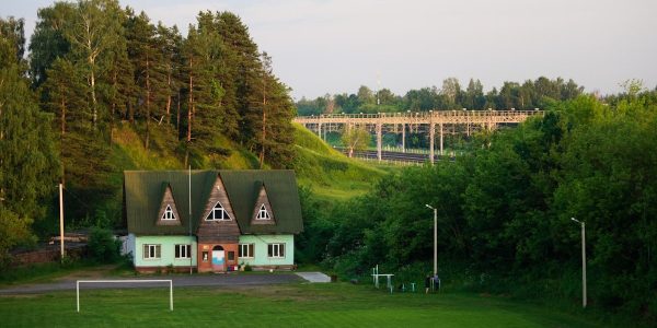 a green house with a soccer goal in front of it