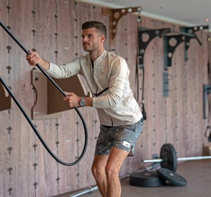 a man holding a gym rope in a gym