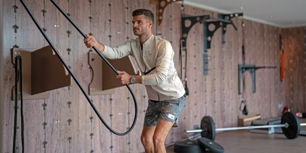 a man holding a gym rope in a gym